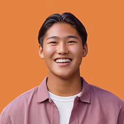 Smiling young Asian man with short black hair against an orange background.